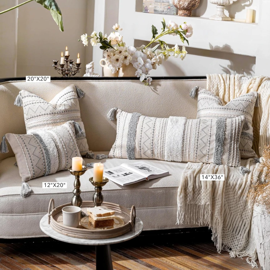 Cozy neutral living room with gray sofa, textured pillows, and Scandinavian decor elements