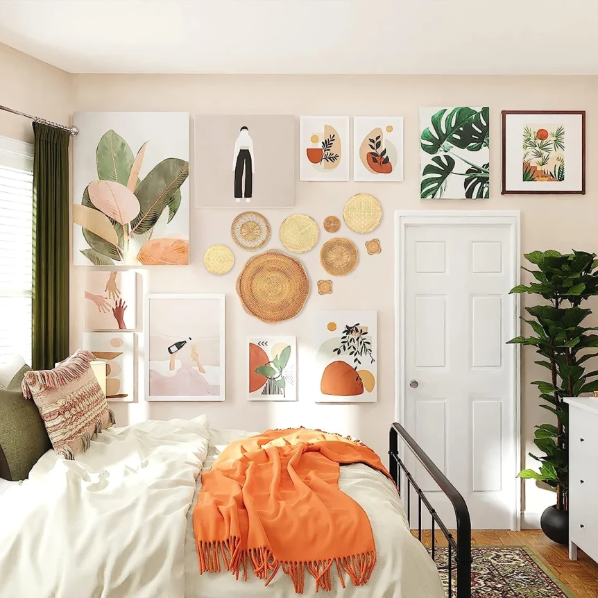 Cozy bohemian bedroom with gallery wall art, orange throw blanket, plants, and layered textiles in warm neutral tones