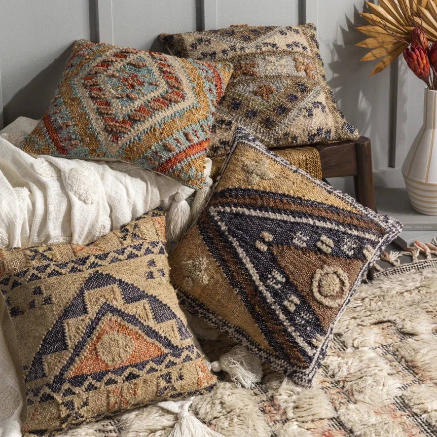 Bohemian decorative throw pillows with ethnic patterns and textures arranged on bed