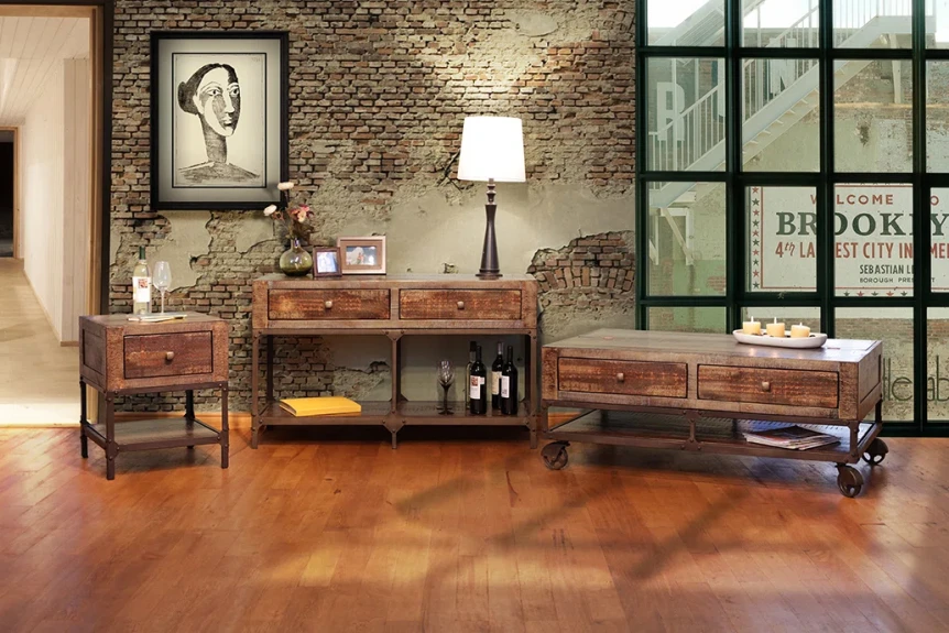 Industrial living room with exposed brick, metal furniture, leather chair, and warm wood flooring