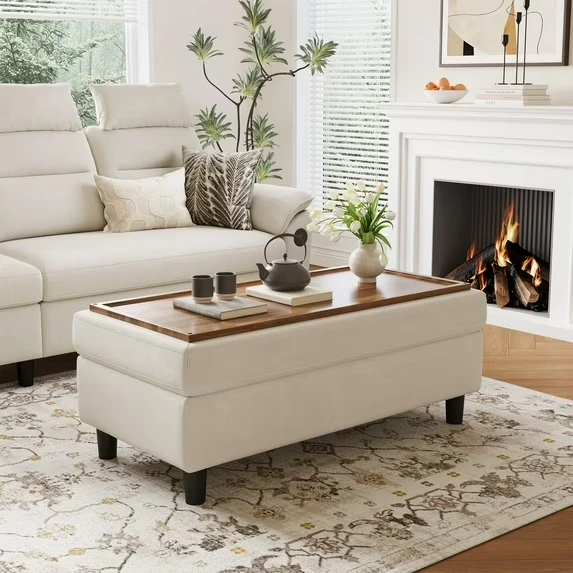 Modern upholstered storage bench with wood tray top in bright living room with fireplace and white sofa