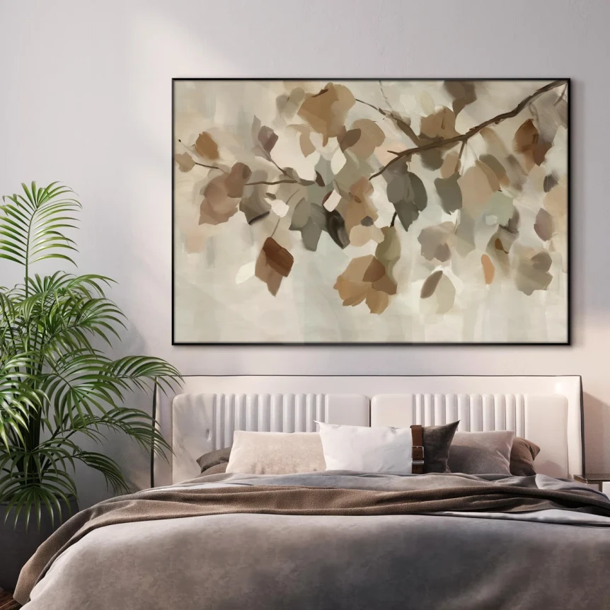 Scandinavian bedroom with neutral botanical art above upholstered bed, flanked by tropical plants and soft gray bedding
