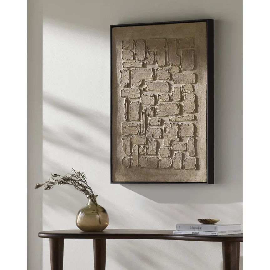 Minimalist textured wall art above console table with vase in neutral Japandi interior design