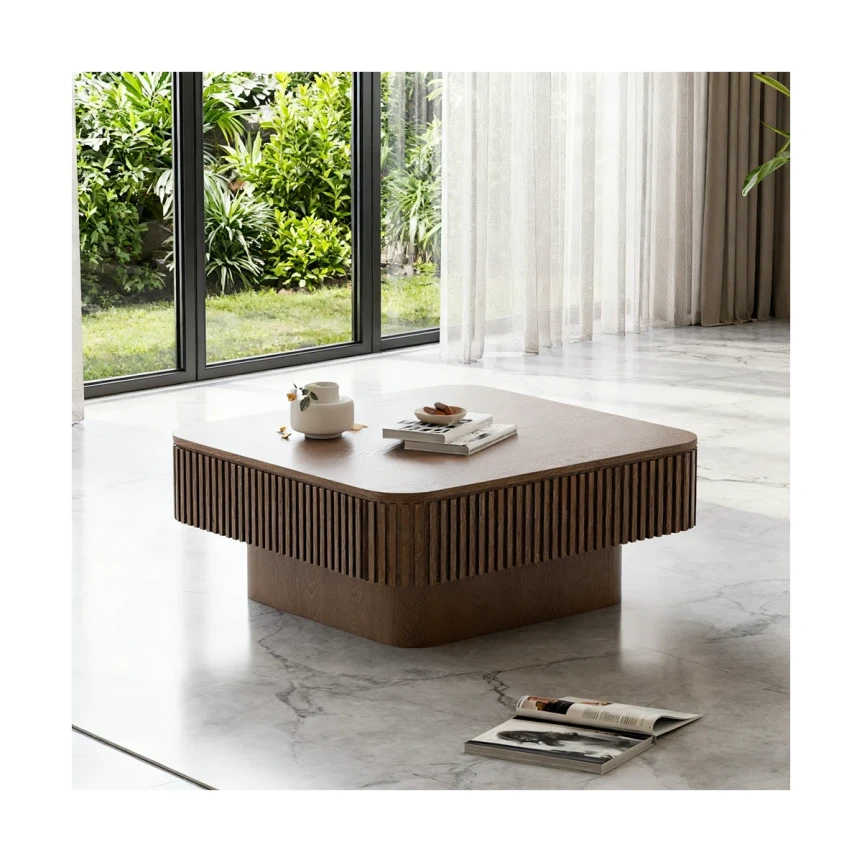 Modern walnut wood coffee table with fluted design in bright living room with white curtains and greenery