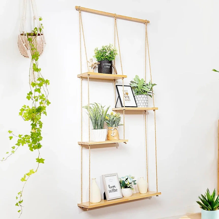 Wooden rope hanging wall shelf with plants and photo frames in bohemian style home decor
