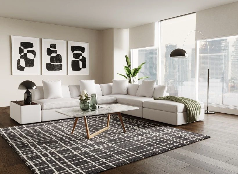 Modern white sectional sofa with chaise in bright living room featuring geometric rug and contemporary decor