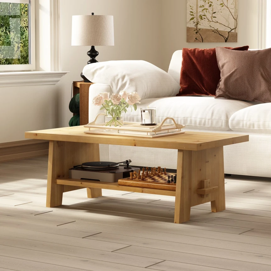 Natural wood coffee table with lower shelf in modern living room with white sofa and decorative pillows