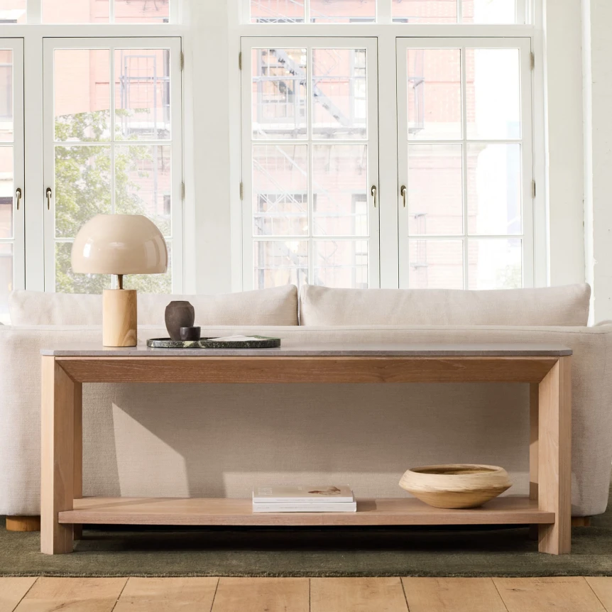 Modern wooden console table with shelf in bright entryway with natural light and minimalist decor