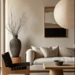 Minimalist Japandi living room with neutral sofa, wooden coffee table, paper lantern, and organic decor elements