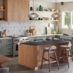 Mid-century modern kitchen with wood island, sage green cabinets, white tile backsplash, and wooden bar stools