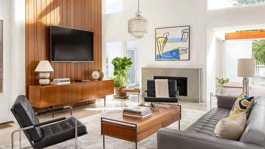 Mid-century modern living room with wood credenza, leather chair, and geometric coffee table