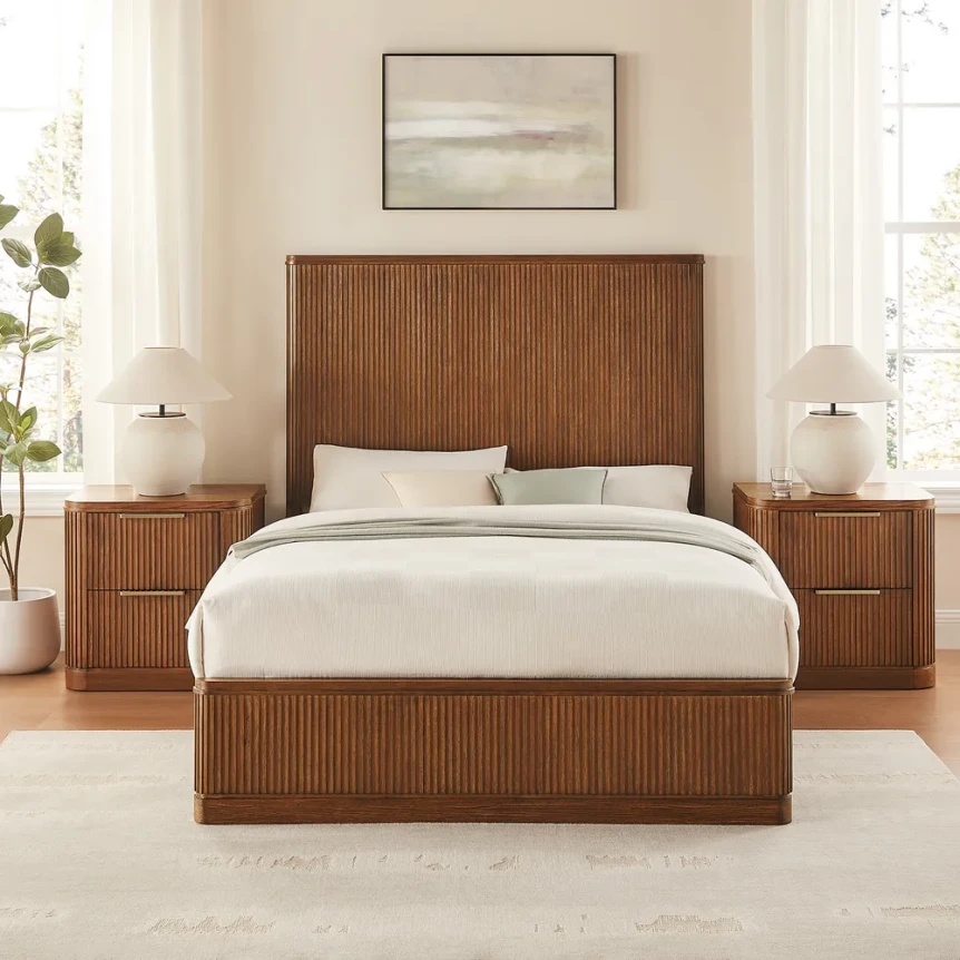 Elegant bedroom with walnut wood bed frame, matching nightstands, white bedding, and minimalist coastal artwork