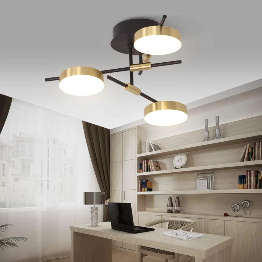 Modern three arm semi flush ceiling fixture with circular LED shades casting even ambient light over a home office with built in shelving