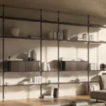 Modern minimalist bookshelf with glass shelves, black metal frame, and curated decor in contemporary living room