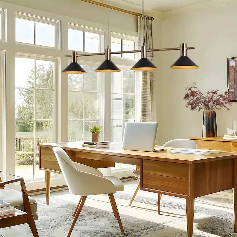 Modern home office with a black and brass linear pendant hung over a wooden desk, a white task chair, and large windows pulling in natural daylight