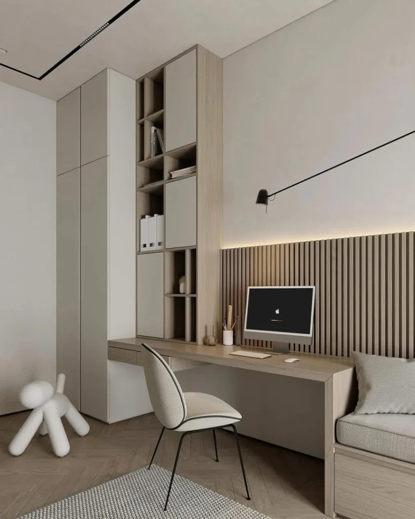 Scandinavian home office with a built in light oak desk, vertical wood slat accent wall, and tall storage cabinets in soft neutral tones