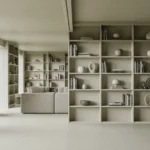 Modern minimalist library with floor-to-ceiling white built-in bookshelves displaying curated decorative objects