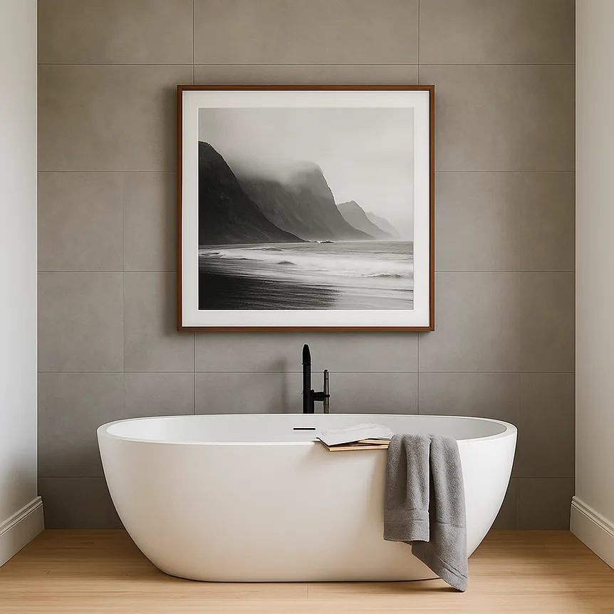 Freestanding oval bathtub in modern bathroom with matte gray tile wall and light wood flooring